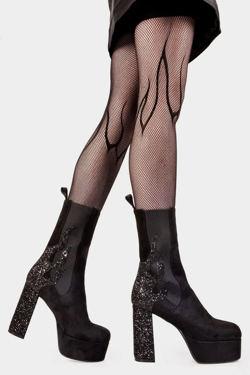 Burning Trails
  
 Apparent Lies Platform Calf Boots Boot in Black Suede. These black vegan Platform Boots feature black glitter flame detail to the back of the heel with a stretchy gusset detail, heat up your style game! Made with eco-friendly materials and 100% cruelty-free, these platform boots are as ethical as they are fiery!
 
 
 - Platform Height
 - Heel Height 
 - Gusset detail 
 - Wide calf and ankle friendly 
 - Platform Sole 
 - Round Toe
 - 100% vegan 
 
 SKU: LMF 2038 - BlackSUEDE/BlackGlitter