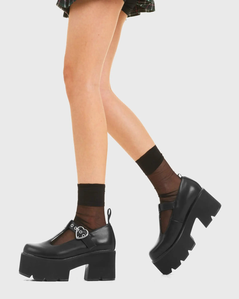 SIMPLY IN LOVE 
  
  Love Story Chunky Mary Jane Shoes in Black faux leather. These vegan western Boots feature a minimalist design with an adjustable heart buckled straps, very cute. Made with eco-friendly materials and 100% cruelty-free, these boots are as ethical as they are romantic!
  
  
  - Platformed
  - Ankle length
  - Silver heart buckle
  - Chunky black sole
  - Rounded toe 
  - 100% vegan 
  
  SKU: LMF 3901 - BlackPU