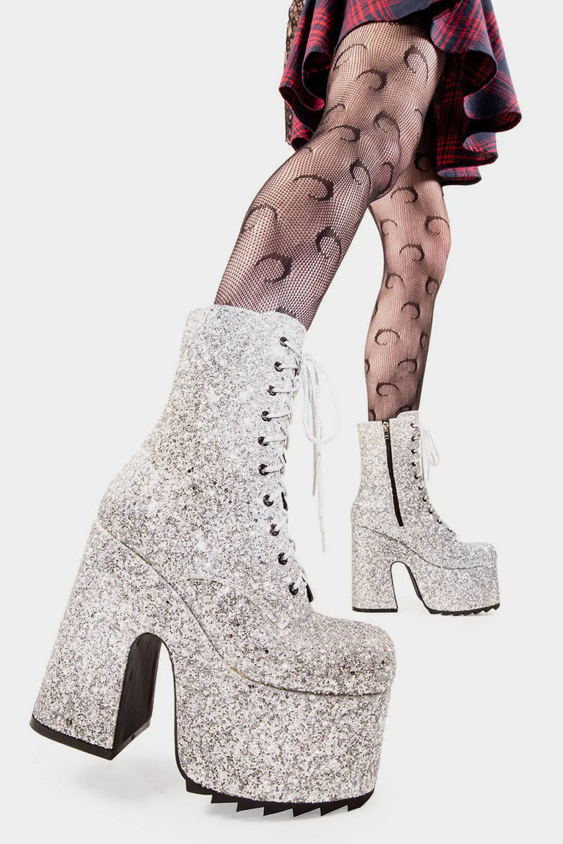 Dazzling Delights
  
  Spotlight Chunky Platform Ankle Creeper Boot in Silver Glitter. These silver vegan Platform Boots feature our iconic glitter detail througout with adjustable lace up detail, shiny perfection to glow with every step. Made with eco-friendly materials and 100% cruelty-free.
  
  
  - Platform Height: 2.3 inch
  - Heel Height: 5.5 inch
  - Black zipper 
  - Silver laces and silver eyelets 
  - Chunky Creeper sole
  - Round Toe
  - 100% vegan 
  
  SKU: LMF 2046 - SilverGlitter