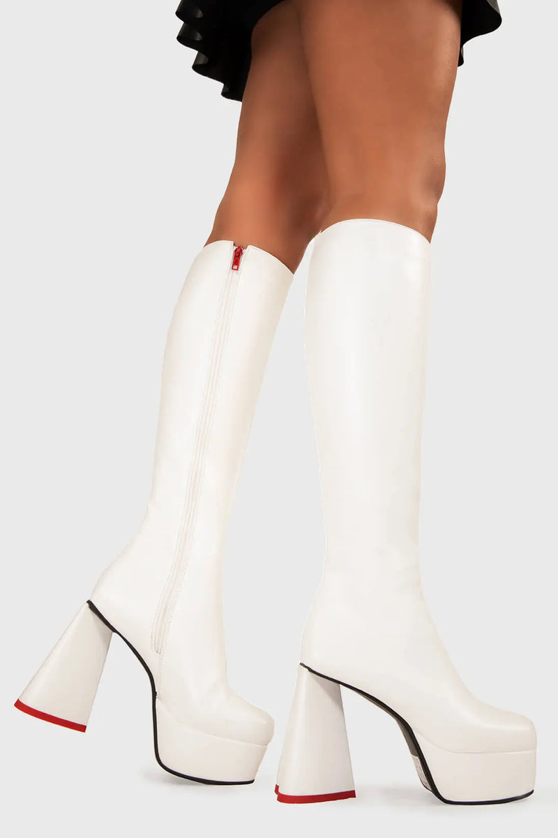 LOVEABLE 
  
  Sweet Talker Wide Calf Platform Knee High Boots in white faux leather. These platform boots feature a minimalist look with a heart shaped heel, keeping it nice and classy. Made with eco-friendly materials and 100% cruelty-free, these platform boots are as ethical as they are chic.
  
  - Platform Height
  - Knee length
  - Heart shaped heel
  - Red sole
  - Wide calf 
  - White zip
  - High Heel
  - 100% vegan 
  
  SKU: LMF 3313 - WhitePU - WIDE FIT