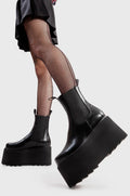 Step Out in Fashion
  
  Time Waster Chunky Platform Ankle Boots in Black faux leather. These flatform shoes feature a minimalist design, with a gusset and two pull tags. Made with eco-friendly materials and 100% cruelty-free, these platform boots are as ethical as they are Edgy
  
  - Platform Height
  - Gusset
  - Two pull tags
  - Flatform Sole
  - Shark's Teeth Grip
  - 100% vegan 
  
  SKU: LMF 3138 - BlackPU