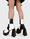 TIME TO DANCE
  
  Wait A Minute Platform Ankle Boots in Black and white faux leather. These platform boots feature a black and white patch work design with a triangle heel, keeping it nice and classy. Made with eco-friendly materials and 100% cruelty-free, these platform boots are as ethical as they are chic.
  
  - Platform Height
  - Ankle length
  - Patch work design
  - Triangle heel
  - High Heel
  - 100% vegan 
  
  SKU: LMF 3330 - BlackPU/WhitePU