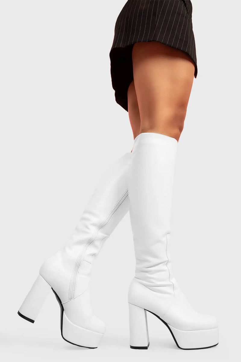 THE TIMELESS ONE
  
  Whatta Showdown Platform Knee High Boots in White faux leather. These White vegan Boots feature an elegant, minimalist design and a Platform sole and heel, perfect for adding height and style to any outfit. Made with eco-friendly materials and 100% cruelty-free, these boots are as ethical as they are stylish.
  
  
  - Platform Height: 1.25 inch
  - Heel Height: 4.2 inch
  - Knee High length
  - White zipper 
  - Platform sole
  - Round toe 
  - 100% vegan 
  
  SKU: LMF 0916 - WhitePU