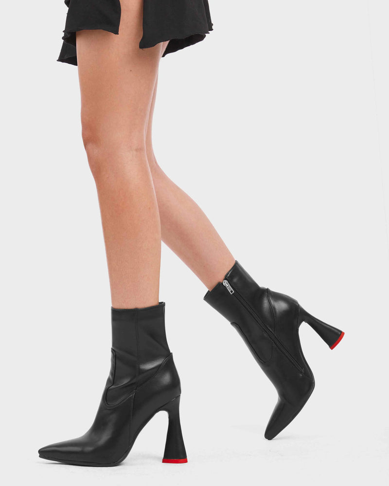 DECEPTION
 
 Who Am I Platform Ankle Boots in Black faux leather. These vegan boots feature a minimalist design with a heart shaped heel and a red heart heart at the bottom. Spreading the love with every step. Also features a functional zip. Made with eco-friendly materials and 100% cruelty-free, these boots are as ethical as they are stylishly sweet!
 
 
 - Platform Height:
 - Low Ankle Length
 - Red Heart Heel
 - Heart Detailing
 - Platform Sole
 - Round Toe
 - 100% Vegan
 
 SKU: LMF 5048 - BlackPU