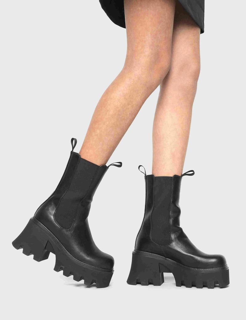 COMFY AND CHUNKY Wipe Out Chunky Platform Ankle Boots in Black faux leather. These vegan Ankle Boots feature an elastic gusset and a chunky platform sole, making them the perfect comfy Boots for any occasion. Made with eco-friendly materials and 100% cruelty-free, these boots are as ethical as they are stylish! - Platform Height: 3.3 inch - Wide ankle friendly - Wide calf friendly - High ankle height - Black elastic gusset - Black pull tab - Chunky Platform sole - 100% vegan SKU: LMF 1086 - BlackPU