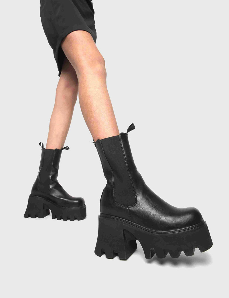 COMFY AND CHUNKY Wipe Out Chunky Platform Ankle Boots in Black faux leather. These vegan Ankle Boots feature an elastic gusset and a chunky platform sole, making them the perfect comfy Boots for any occasion. Made with eco-friendly materials and 100% cruelty-free, these boots are as ethical as they are stylish! - Platform Height: 3.3 inch - Wide ankle friendly - Wide calf friendly - High ankle height - Black elastic gusset - Black pull tab - Chunky Platform sole - 100% vegan SKU: LMF 1086 - BlackPU